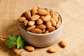 Almonds in a  bowl on wooden table