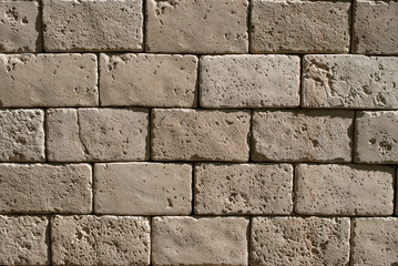 Rough decorative wide brickwork, imitation of old vintage stone, exterior brick wall textured background