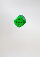 flying object green dice.white background.uncertainty and hazard idea concept design
