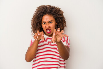 Young african american woman with curly hair isolated on white background showing claws imitating a cat, aggressive gesture.