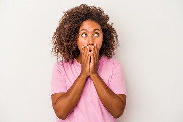 Fototapeta na wymiar Young african american woman with curly hair isolated on white background thoughtful looking to a copy space covering mouth with hand.