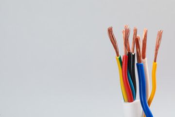 Many stripped electrical wires on light background, closeup. Space for text