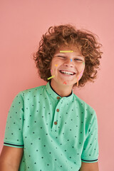 Boy with stylish and creative look looking at camera with happy face