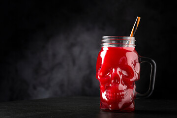 Halloween drink. Blood drink in skull glass.