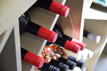 Wine bottles on wooden shelf in wine store