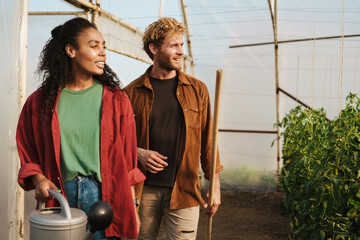 Smiling mid aged couple of gardeners