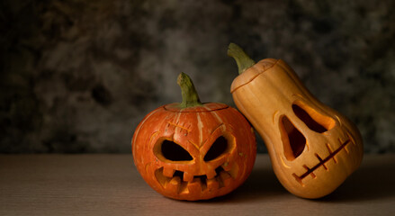 Festive scary halloween pumpkins on wooden table