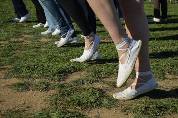 feet of several people in line dancing sardanas