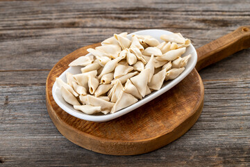 frozen ravioli on wood background. Mediterranean cuisine delicacies
