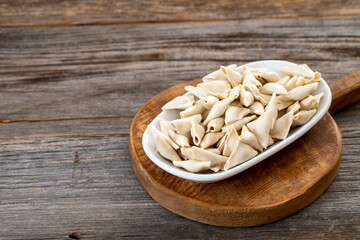 frozen ravioli on wood background. Mediterranean cuisine delicacies. Copy space