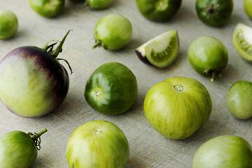Green tomatoes unripe edible vegetable for zero waste cooking. Heirloom tomatoes from own garden.