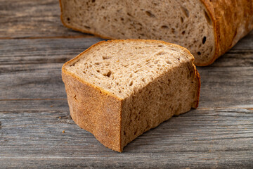 Organic sourdough bread on wood background.