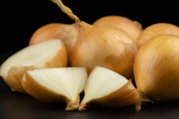 Whole and haft group pile ingredient of fresh onion  group isolated on black background