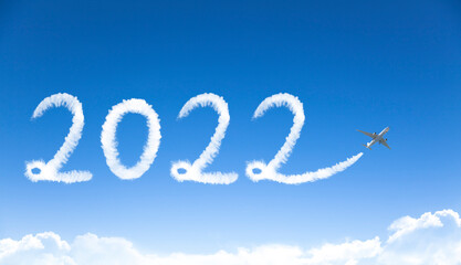 Naklejka na ściany i meble happy New year 2022 concept. cloud drawing by airplane in sky