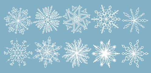 Beautiful set white snowflakes on a blue background for winter design. Collection of Christmas New Year elements. Frozen silhouettes of crystal snowflakes. Modern design apartment. Holiday wallpapers.