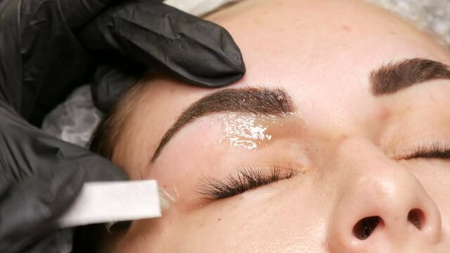 Removal of unnecessary, excess hairs on face. Eyebrow correction using warm wax at the beautician
