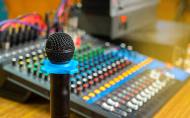 Microphone close-up on  blurred sound mixer background