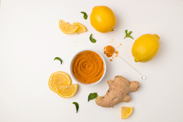 Fresh turmeric, ginger and sour lemon slices ingredients on a white background. Healthy natural vitamin drink that protects health from viruses.