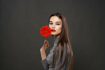 pretty brunette red flower near face makeup dark background