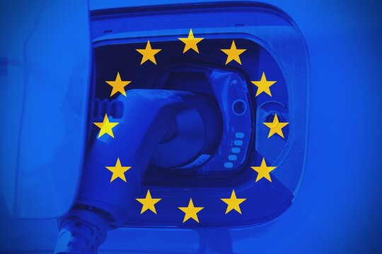 Close up of a plug while charging a car. Concept of electric cars in Europe.