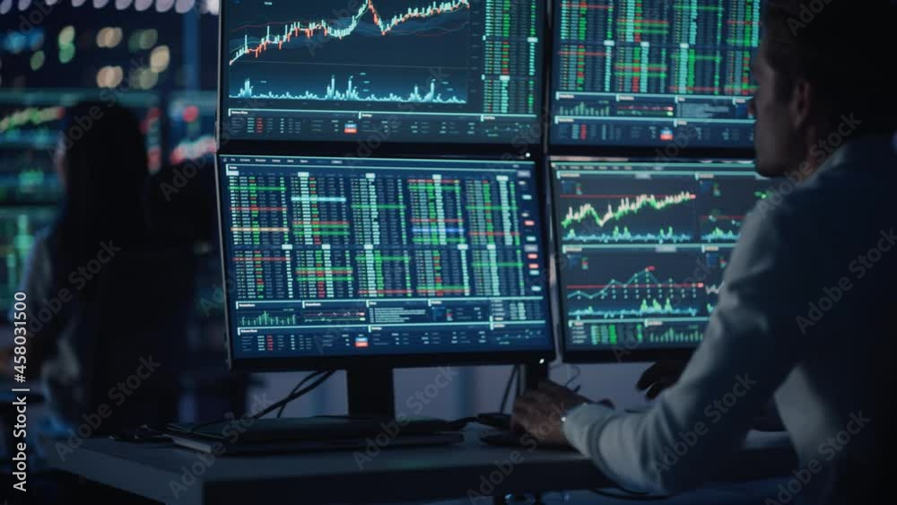Poster financial analysts and day traders working on a computers with multi-monitor workstations with real-