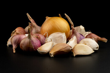 Whole group pile ingredient of fresh onion garlic group isolated on black background