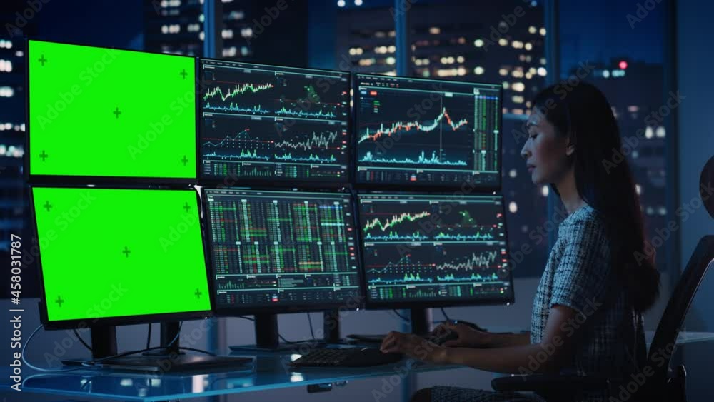 Poster Financial Analyst Working on Computer with Multi-Monitor Workstation with Green Screen Chroma Key Mock Up Template and Real-Time Stock Charts. Businesswoman Works in Investment Bank in the Evening.