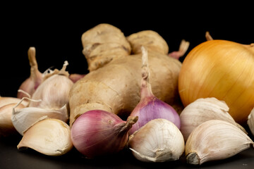 Whole group pile ingredient of fresh onion garlic ginger group isolated on black background