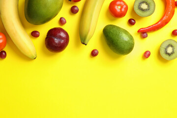 Set of different vegetables and fruits on yellow background