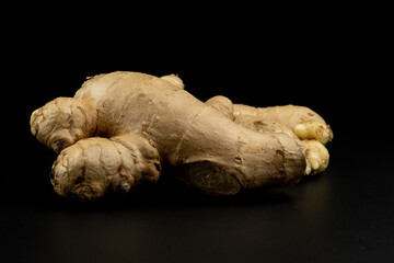 Whole group pile ingredient of fresh ginger group isolated on black background