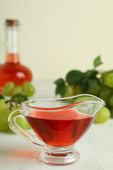 Concept of grape vinegar on white textured table