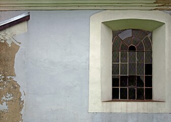 Fototapeta premium General view and architectural details of the Protestant church built in plastered red brick at the beginning of the 19th century in the village of Rańsk in Masuria, Poland.