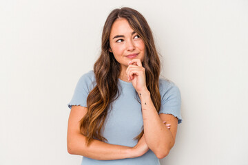 Young caucasian woman isolated on white background looking sideways with doubtful and skeptical expression.