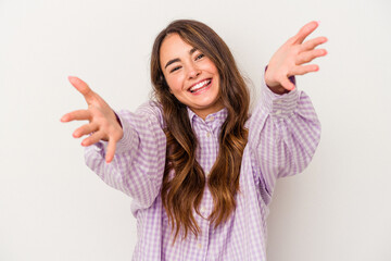Young caucasian woman isolated on white background feels confident giving a hug to the camera.