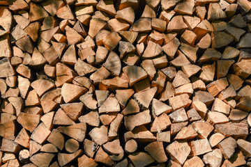 A wall with neatly stacked chopped pieces of firewood
