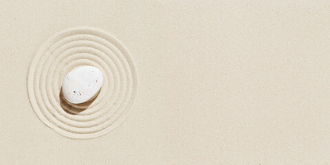 Fototapeta na wymiar Aesthetic minimal background with zen stone on sand. Pattern in Japanese Zen Garden