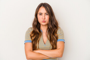 Young caucasian woman isolated on white background blows cheeks, has tired expression. Facial expression concept.