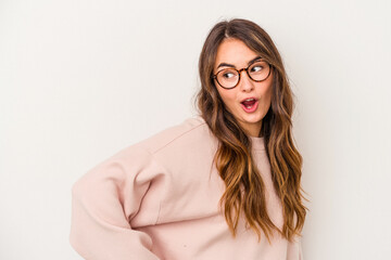 Young caucasian woman isolated on white background looks aside smiling, cheerful and pleasant.