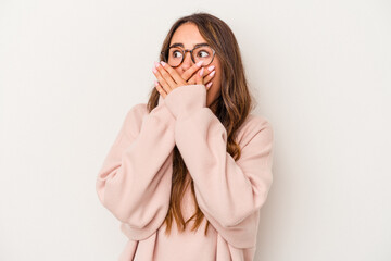 Young caucasian woman isolated on white background thoughtful looking to a copy space covering mouth with hand.