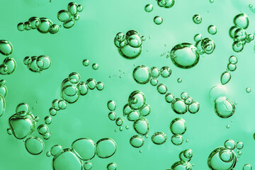 Close up macro Aloe vera gel cosmetic texture blue background with bubbles.