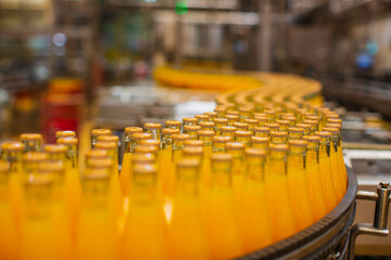 Beverage factory interior. Conveyor flowing with bottles for juice