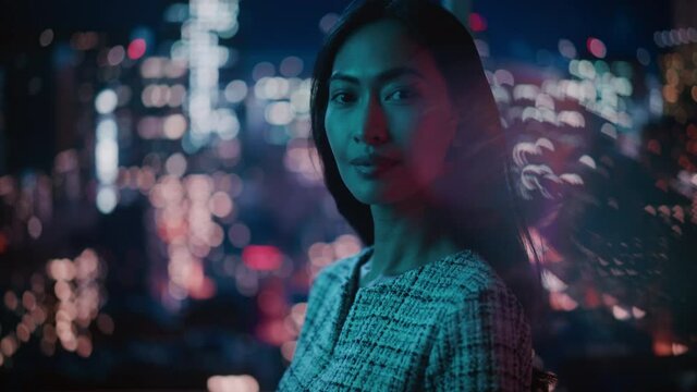 Beautiful Asian Female Portrait Standing on City Street with Neon Lights Late in the Evening. Authentic Adult Confident Woman Posing For Camera, Smiling in the Night on Downtown Business Street.