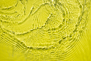 Water spills on a light green yellow background. Beautiful bursts and glare. Summer mood. Minimal style. Natural sunlight and shade. Backdrop for cosmetic ideas and magazines