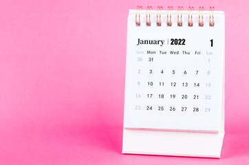 Fototapeta na wymiar January 2022 desk calendar on pink.