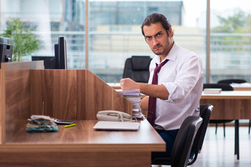 Young male employee and too many work in the office