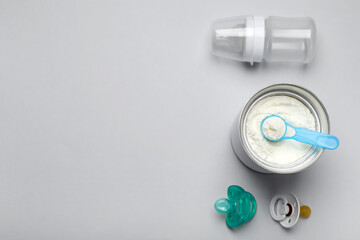 Obraz na płótnie Canvas Flat lay composition with powdered infant formula on light background, space for text. Baby milk