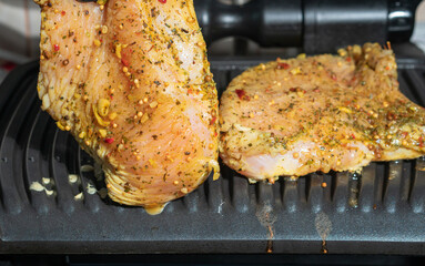 Chicken meat without bone on an electric grill without adding oil, low fat food preparation