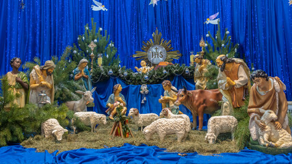 Christmas nativity scene with baby Jesus, Mary and Joseph in the manger with sheeps. Christmas...