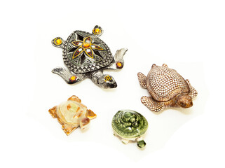 Beautiful souvenir Turtle with stones . The concept of four turtles. On an isolated white background