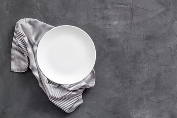 Table setting for dinner. Empty plate on napkin - dishware top view
